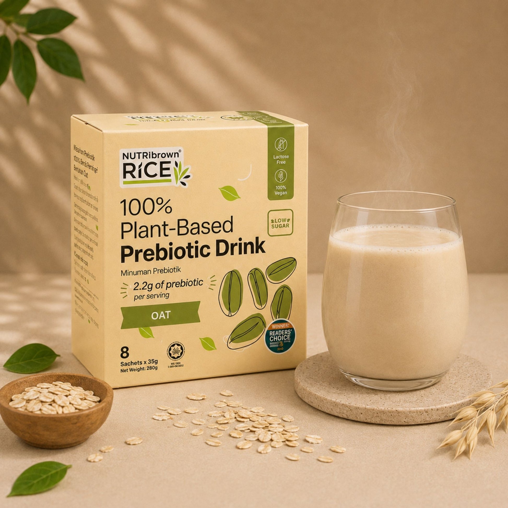 A box of NutriBrown Rice 100% Plant-Based Prebiotic Drink in Oat flavor, shown next to a glass of the creamy beige drink on a coaster, with oats and leaves in a styled setting.