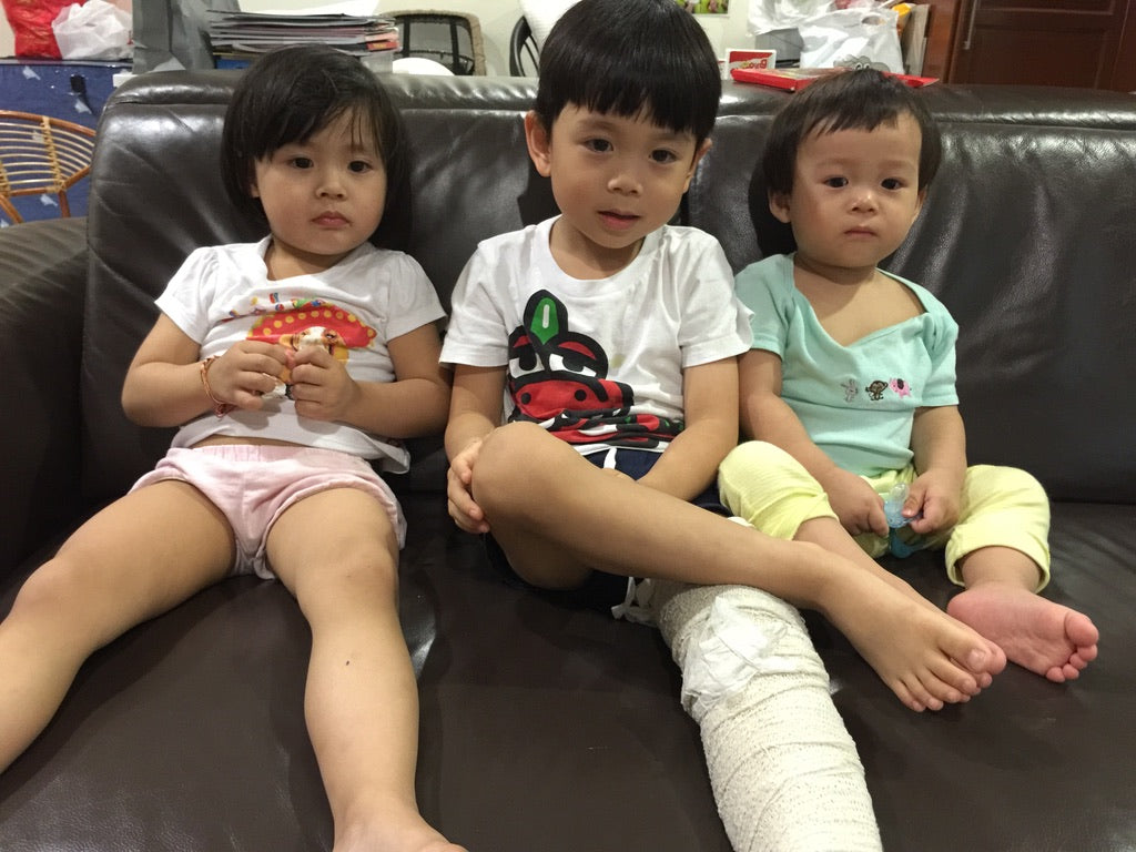 The couple's children at home; their eldest son's leg bandaged during his bone infection recovery.